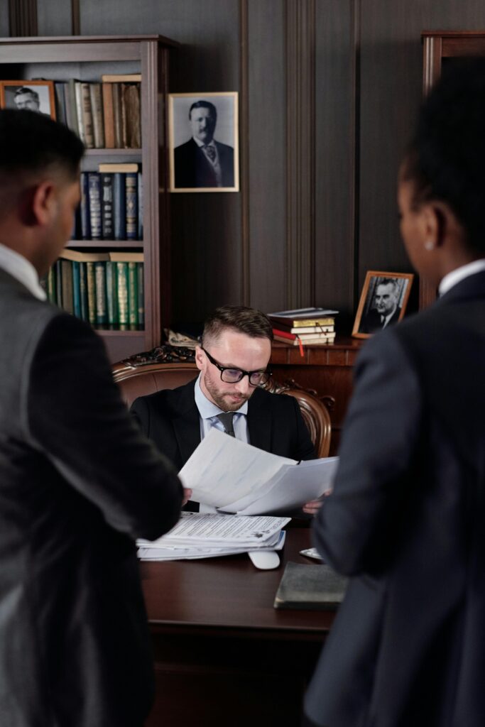 Business professionals discussing important legal documents in an office setting.